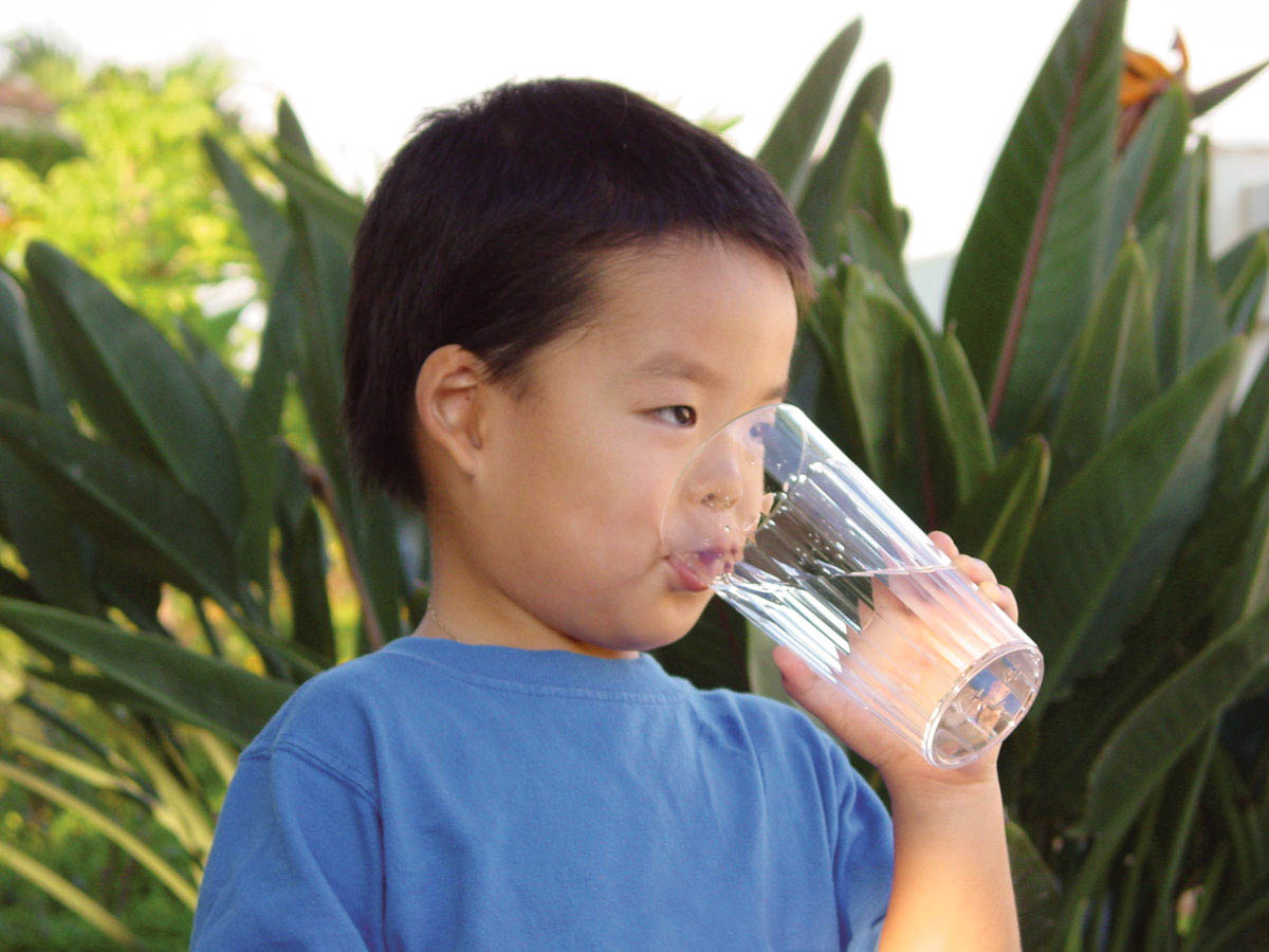 young boy drinking water